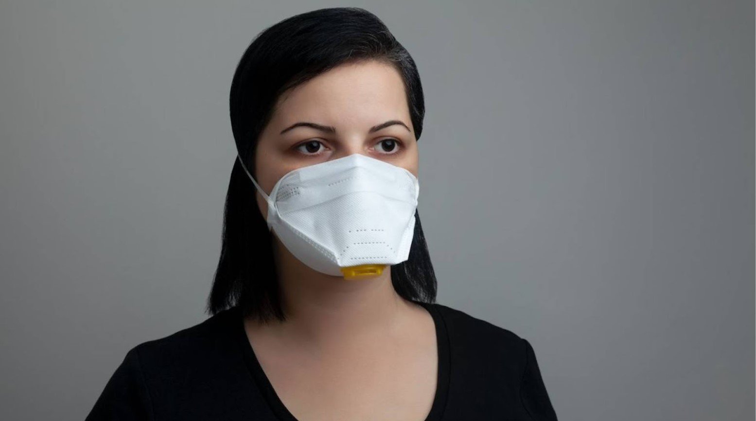 A woman wearing an N95 face mask